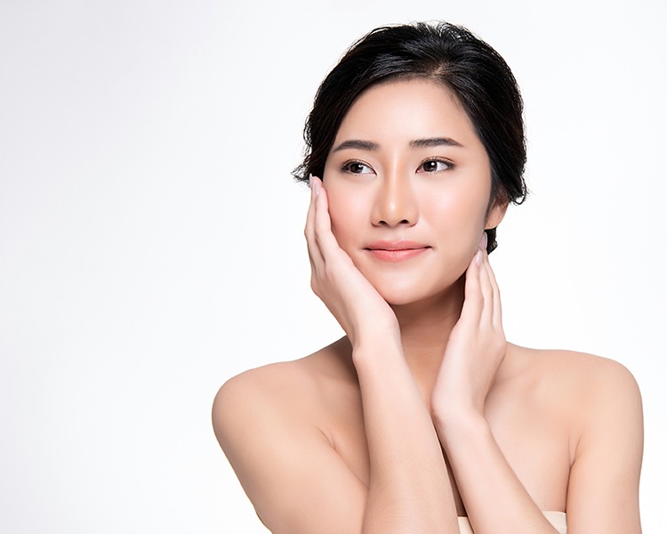 Woman feeling face with nice smooth skin
